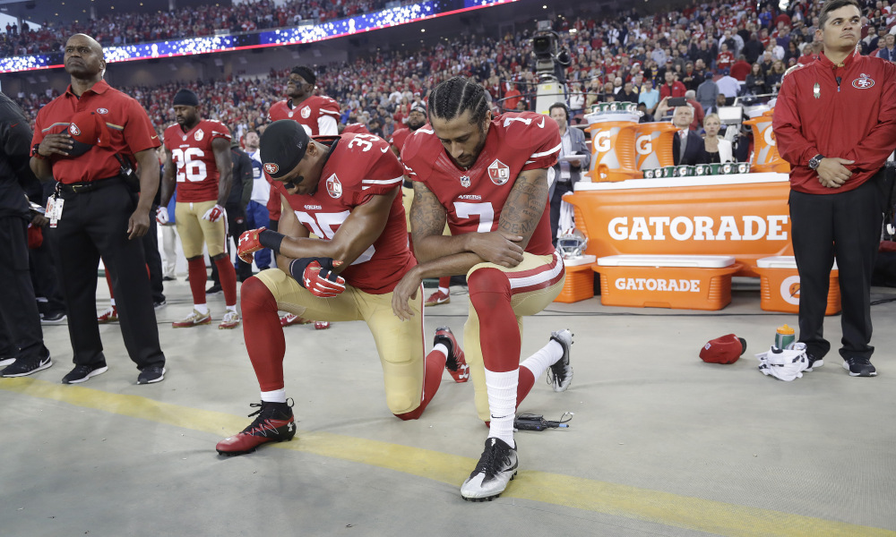 San Francisco 49ers safety Eric Reid (35) and quarterback Colin Kaepernick (7) kneel during the national anthem before an NFL football game against the Los Angeles Rams in Santa Clara, Calif., Monday, Sept. 12, 2016. (AP Photo/Marcio Jose Sanchez) ORG XMIT: FXN