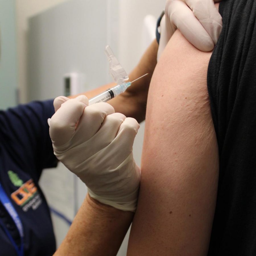 Michael Taber receives his flu shot at the COS Health Center.