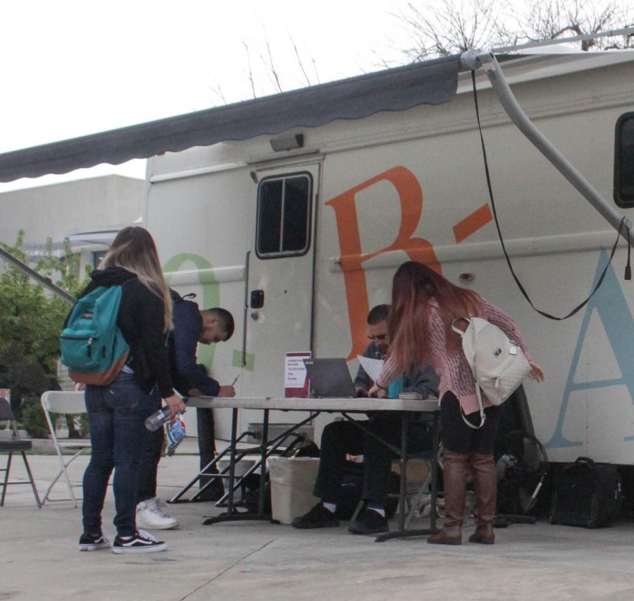 Students+are+volunteering+to+donate+their+blood+in+the+quad.