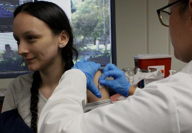 Nurse Laura Ortega administering a flu shot to Erin Hernandez. If tomorrow is inconvenient then future ones will be given in the Heath Centers on the Tulare and Hanford Campuses.