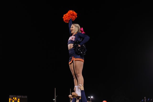 Claire Cattaneo is held up in the air by bases Savannah Weirick, Mirian Campos, and backspot Bailey Cooper as they cheered on the Giants in Modesto. Image provided by Cheer Coach Tiffany Ruiz.