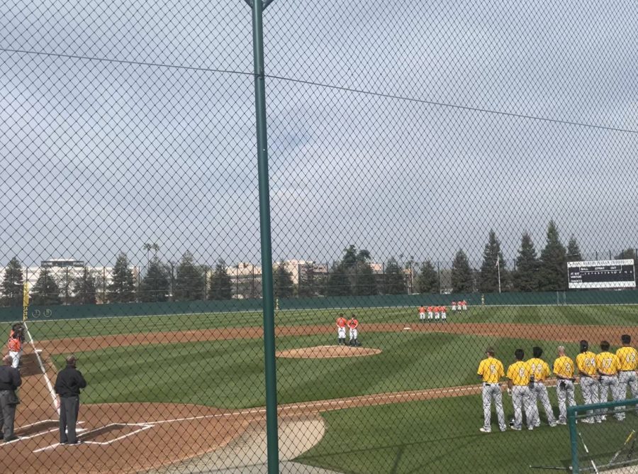 COS Baseball salutes the flag before their home game against Merced