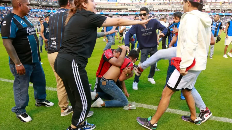 Atlas fans (Red Shirts) getting attacked by Queretaro fans